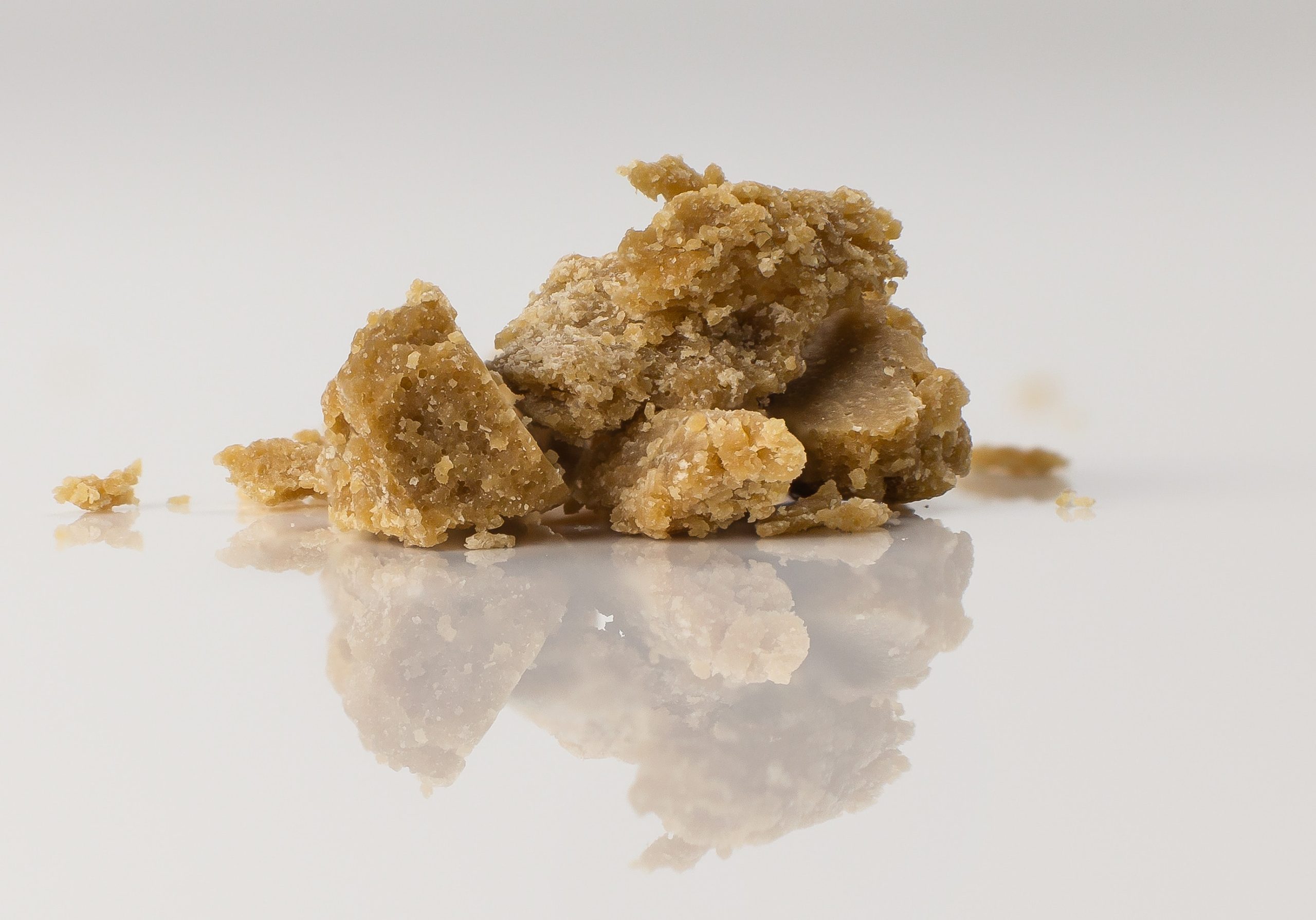 cannabis concentrate atop a white table surface